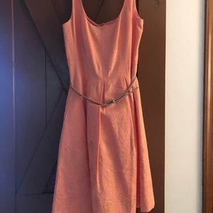 Women’s peach colored belted tank dress.